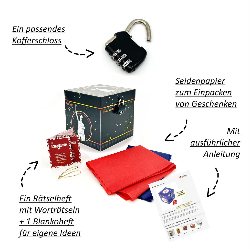 Schwarze Geschenkbox mit vielen goldenen Sprenkeln und Hermannsdenkmal-Illustration. Neben der Box liegen ein kleines schwarzes Zahlenschloss, rotes und blaues Seidenpapier, ein Rätselheft und eine Anleitung.