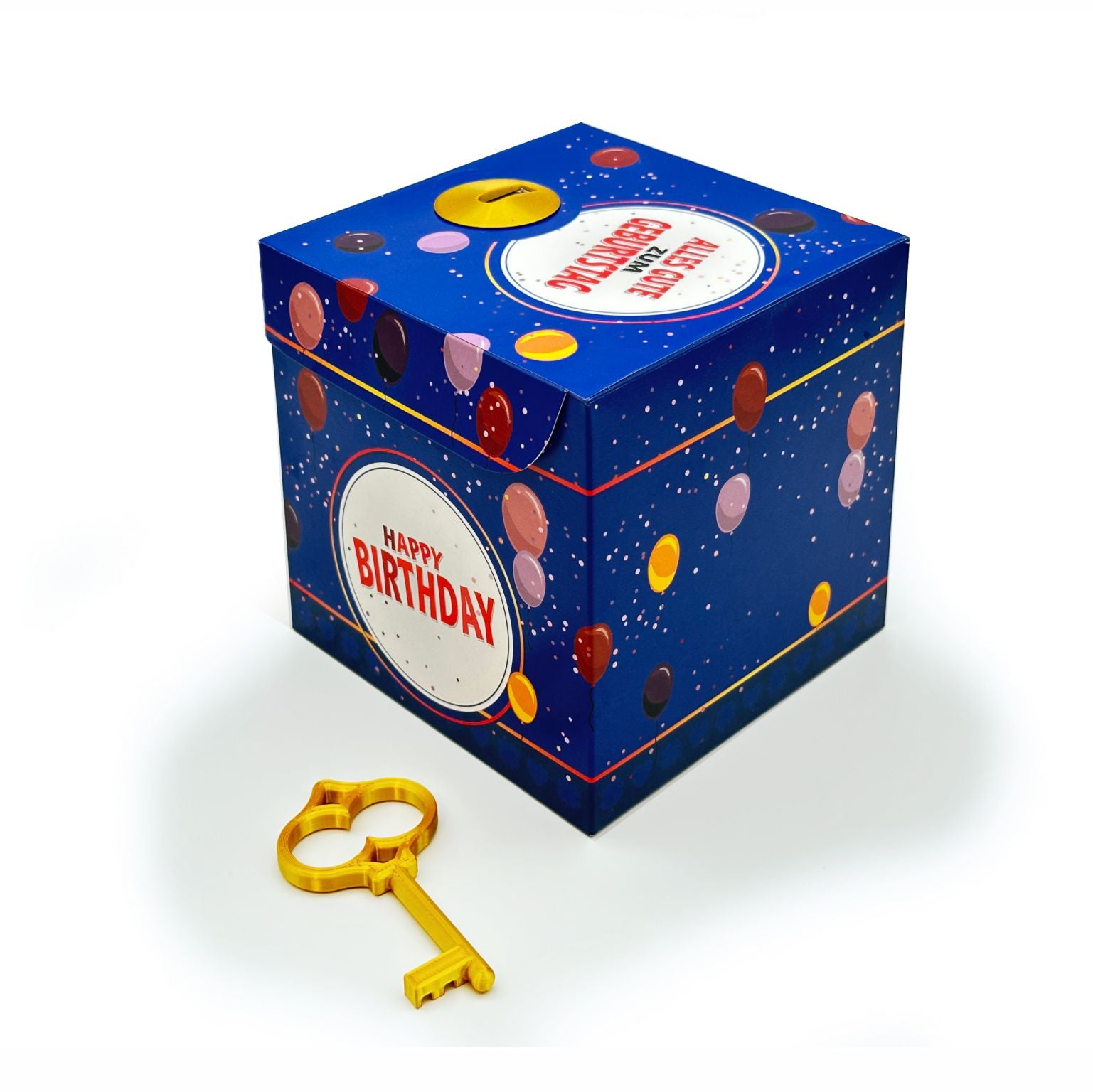 Geschlossene Schlossbox zum Geburtstag im blauen Ballon-Design mit rundem Schriftzug ‚Happy Birthday‘, dekorativer goldener Schlüssel liegt vor der Box, auf weißem Hintergrund.